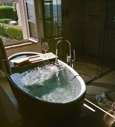 a large bath tub sitting next to a window