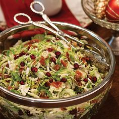 a salad with cranberries and lettuce in a bowl on a table