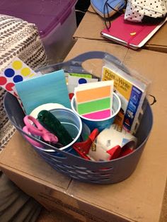 a basket filled with craft supplies on top of a table