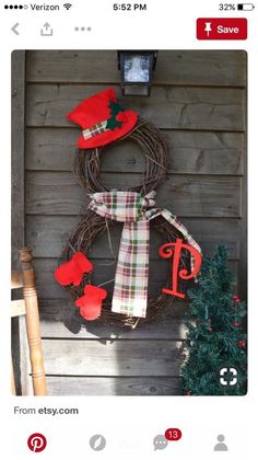 an image of a christmas wreath on the side of a house that is decorated with red and green decorations