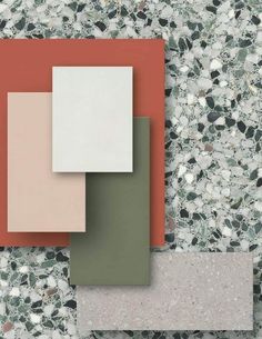 an assortment of different colors and shapes of tiles on the ground, including red, green, gray, and white