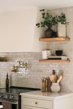 a kitchen with white brick walls and open shelving above the stove, surrounded by wooden shelves