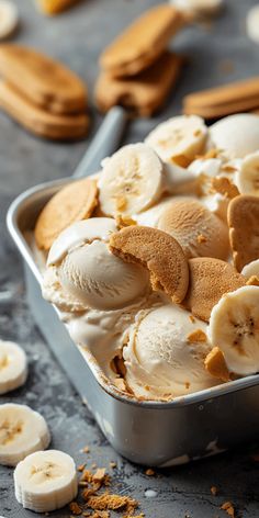 a pan filled with ice cream and sliced banana's on top of a table