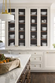 a kitchen filled with lots of white dishes