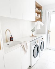 a washer and dryer in a white kitchen