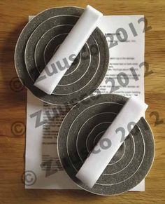 two black and white grinding wheels on top of paper