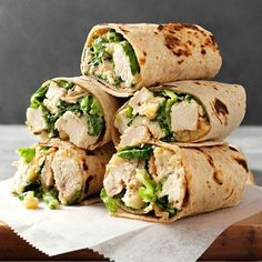 four wraps stacked on top of each other with meat and veggies in them