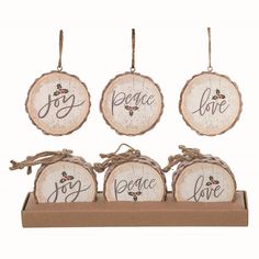 four wooden ornaments with the words peace and love on them