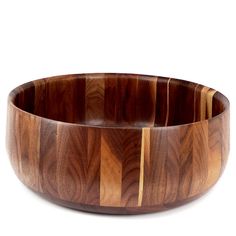 a wooden bowl sitting on top of a white table