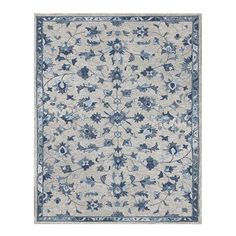 an area rug with blue and white flowers on the side, in front of a white background