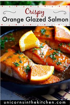 orange glazed salmon in a skillet with lemons and parsley on the side