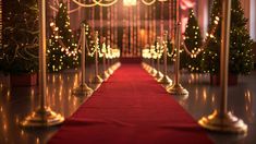 a red carpeted aisle lined with candles and christmas trees