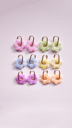 six pairs of small flower clip on earring set in assorted colors and sizes