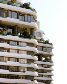 a very tall building with balconies and plants on it