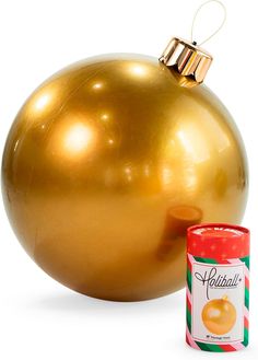 a gold christmas ornament next to a can of candy