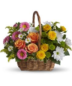 a basket filled with lots of colorful flowers