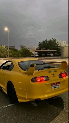 a yellow sports car parked in a parking lot