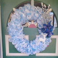 a wreath made out of plastic bottles on the front door