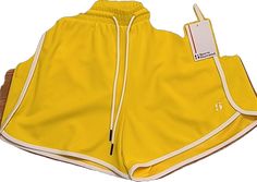 Casual Yellow Activewear Of Short Length, Yellow Sportswear Bottoms For Workout, Casual Yellow Athletic Shorts For Sports, Yellow Sports Shorts For Summer, Yellow Athletic Shorts With Elastic Waistband For Sports, Sporty Yellow Gym Bottoms, Yellow Sportswear Bottoms For Spring, Yellow Activewear With Built-in Shorts For Spring, Yellow Athletic Shorts For Gym And Summer