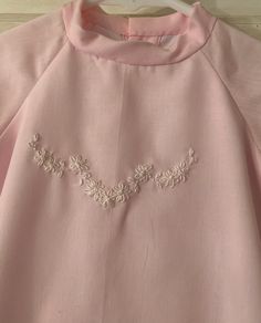 "A soft pink cotton day gown, hand embroidered with white flowers and trimmed with white lace along the bottom and sleeves. This is a one of a kind creation for your precious little one, or a perfect baby gift. The dress is made of all new materials in the old-fashioned way. It is lined and finished with French seams and buttonholes, and hand finished hems. Tiny matching buttons close the back. Sized newborn to 3 months, it measures 10 1/2\" across under the armholes by 22 inches long. The match Embroidered Long Sleeve Baptism Dress, Spring Baptism Dress With Lace Trim And Long Sleeves, Spring Long Sleeve Baptism Dress With Lace Trim, Embroidered Pink Baptism Dress, Pink Embroidered Dress For Baptism, Pink Embroidered Dresses For Baptism, Pink Embroidered Dress For Daywear, Pink Floral Embroidery Dress For Baptism, Vintage Embroidered Dress For Baptism