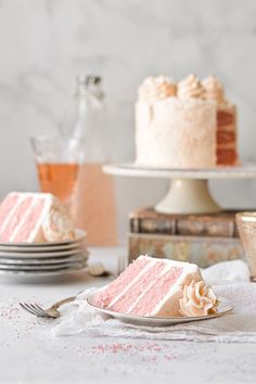 a slice of cake sitting on top of a white plate next to plates and cups