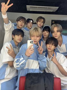 the boys are posing for a photo in front of their cell phone while wearing blue and white outfits