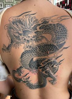 a man with a dragon tattoo on his back