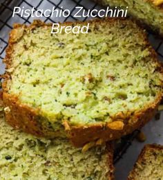 sliced zucchini bread sitting on top of a cooling rack with the words pistachio zucchini bread