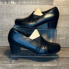 Clarks - Rosalyn Adele “Black Leather” 10955 Brand New Shoes In Box. Never Worn. No Rips, Tears, Or Stains. Smoke Free Environment. Ships Carefully Packaged And Boxed Right Away. Let Us Know If You Have Any Questions! 10955 If You’re Interested In Multiple Pairs From Our Closet We Offer Bundle Deals So Feel Free To Look Around, Like, And Bundle! Medium Width Slip-on Court Shoes For Office, Black Leather Shoes With Rubber Heel Cap For Work, Black Leather Shoes With Almond Toe For Spring, Elegant Synthetic Leather Shoes With Round Toe, Black Slip-on Heels With Round Toe, Black Leather Shoes For Fall Formal Occasions, Classic Synthetic Formal Boots, Classic Formal Synthetic Boots, Classic Slip-on Synthetic Court Shoes