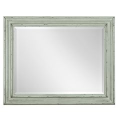 a white framed mirror with green trimmings on the edges and an old - fashioned frame