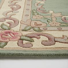 an area rug with flowers and scrolls on it