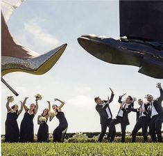 a group of people dressed in black and white posing for the camera with their feet up