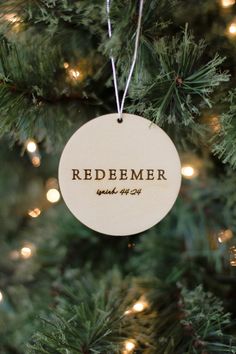 a wooden ornament hanging on a christmas tree that says, redember