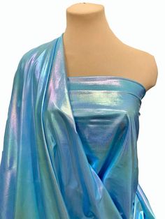 a mannequin is wearing a blue dress with metallic foil on the top and bottom