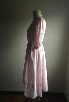 "1980s dress label-Di Nuovo solid pink cotton feel v-back bust seams from shoulder to waist button sleeve cuff pleated sleeve pleated waist side zipper (TALON) ruffle tier hem good vintage condition, light wear label size 6 (see below) measures, lying flat, shoulder-15\" chest-19\" waist-13 1/2\" hip-free sleeve-16\" shoulder to waist-16 1/2\" length-46\"" Dress Label, Pleated Sleeves, 1980s Dresses, Sleeve Cuff, Pink Cotton, Label Sizes, Olympia, Side Zipper, Side Zip