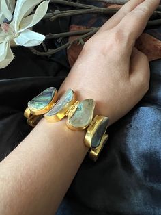 Handcrafted in brass with beautiful abalone shells and gold plating. Pick this gorgeous bracelet and make a stunning statement! Adjustable Wrist size 2.4, 2.6 Weight of Bracelet: 38 grams  Material: Brass, Gold Plated, Abalone Shells( Pawa Shell)