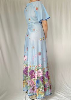 "Blue floral maxi dress Butterfly sleeves Semi sheer Made in Italy 100% nylon Labelled Size 48 (please go by measurements) 15.5\" shoulders 11.5\" sleeves 18\" pit to pit 32\" waist Free hips 55\" length Model is 5'4\" and 120 lbs." Stretch Blue Maxi Dress With Floral Print, Fitted Blue Floral Print Maxi Dress, Fitted Blue Maxi Dress With Floral Print, Blue Short Sleeve Stretch Maxi Dress, Blue Fitted Maxi Dress For Garden Party, Light Blue Floral Print Maxi Dress For Daywear, Light Blue Floral Maxi Dress For Daywear, Fitted Full-length Maxi Dress For Daywear, Full Length Spring Daywear Dress