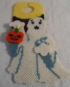 a beaded keychain with a ghost holding a jack - o - lantern