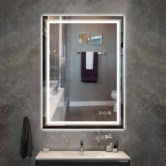 a bathroom with a sink, mirror and towel rack in it's reflection on the wall