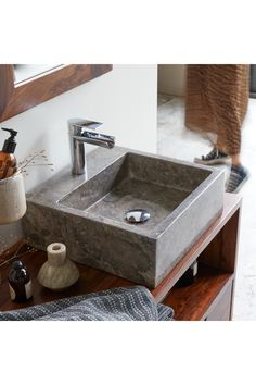 a bathroom sink sitting on top of a wooden counter