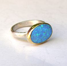 OPAL RING You are looking at a beautiful HAND MADE silver and gold ring with opal stone. The stone are setting in 14k gold bezel It is impressive, powerful and very beautiful ring. Made to order any size.. This ring can be made to order in any size. Please note your desired size in the message to seller area at checkout. size stone is 10mmX14mm width ring: 3mm Come in a gift box. Fallow me on facebook for newest updates. http://www.facebook.com/pages/Orit-Naar-jewelry/174677569247132?sk=wall Recycled Gold Ring, Opal Ring Silver, Mothers Day Rings, Blue Opal Ring, White Opal Ring, Diamond Cluster Engagement Ring, Handmade Engagement Rings, Opal Ring Gold, Metal Smithing