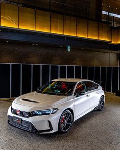 a white car parked in front of a building