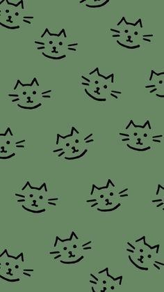 a green background with black cat faces on it