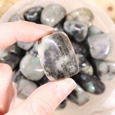 a person holding a rock in their hand