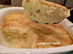 a piece of bread is being lifted from a casserole dish