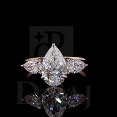 an engagement ring with three pear shaped diamonds