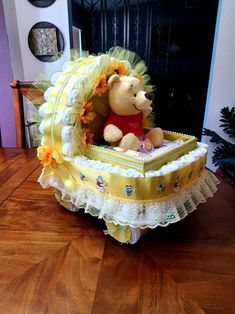 a winnie the pooh diaper cake sitting on top of a table