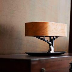 a table lamp sitting on top of a wooden dresser