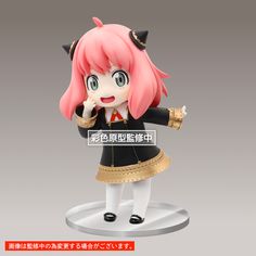 an anime character figurine with pink hair and black clothes, holding her hand to her mouth