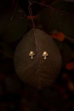 A second style of little golden solid brass (not plated) mushrooms on solid sterling silver posts with sterling silver backs for all you fellow mushroom lovers and fungi fanatics out there. These little cuties are just ever so slightly larger than my other mushroom studs and they have a different look. Which is your favorite? These little studs are lightweight and easy to wear. I added a patina to ad an antique feel and enhance the texture and details. I absolutely love these sweet little mushro Mushroom Stud Earrings, Whimsical Gold Jewelry With Mushroom Design, Whimsical Gold Earrings With Mushroom Design, Whimsical Gold Mushroom Earrings, Gold Earrings With Mushroom Design For Gift, Gift Gold Earrings With Mushroom Design, Mushroom Earring, Crescent Moon Jewelry, Jewellery Photography Inspiration